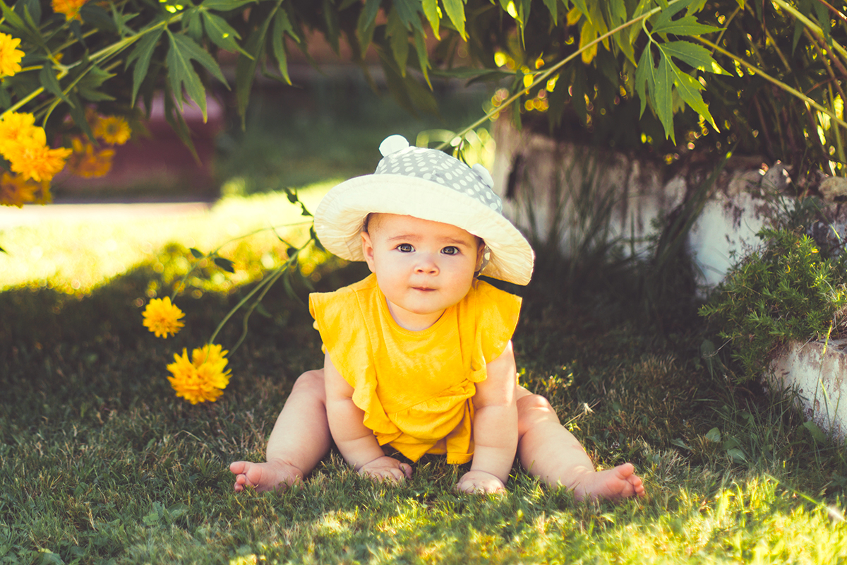 bébé avec un chapeu pour se protéger du soleil pendant l'été